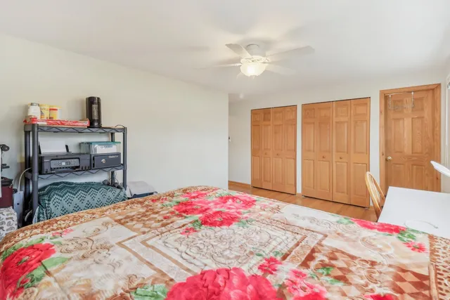 a bedroom with a bed and a chandelier
