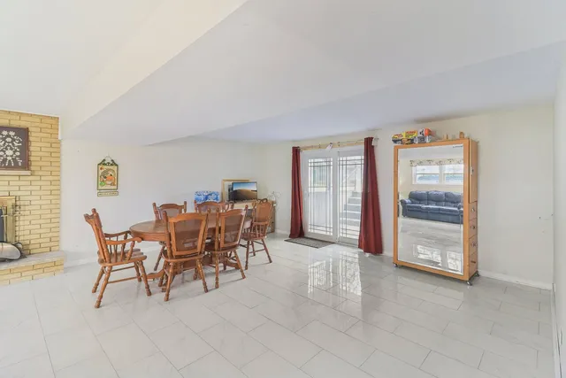 a dining room with furniture and a window