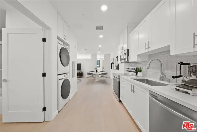 a kitchen with a sink a washer and dryer