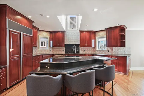 a kitchen with stainless steel appliances granite countertop a sink refrigerator and microwave