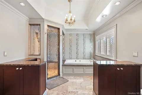 a bathroom with a granite countertop sink a large mirror and a bathtub