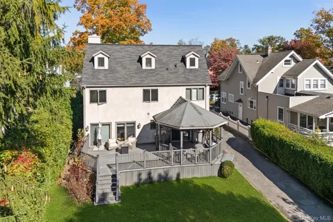 a aerial view of a house with a yard table and chairs