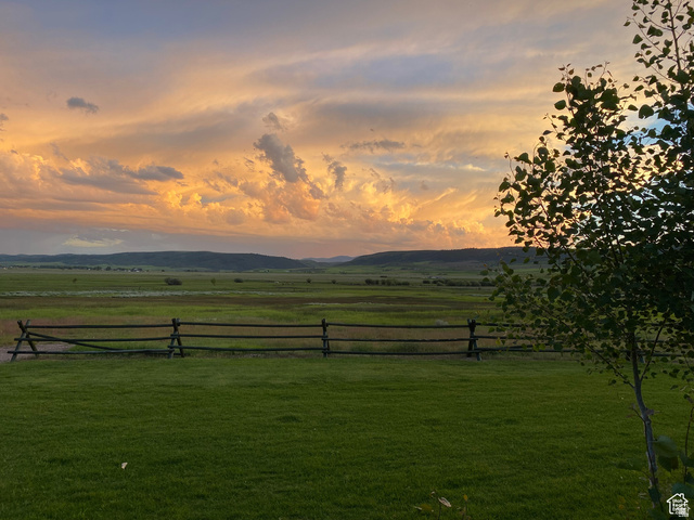 79 Auburn Forest Road Auburn, WY 83111 - Photo 2 of 76 Yard at dusk featuring a rural view and a mountain view
