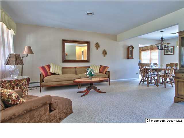 54 Oakfield Road Toms River, NJ 08757 - Photo 8 of 25 a living room with furniture and a dining table