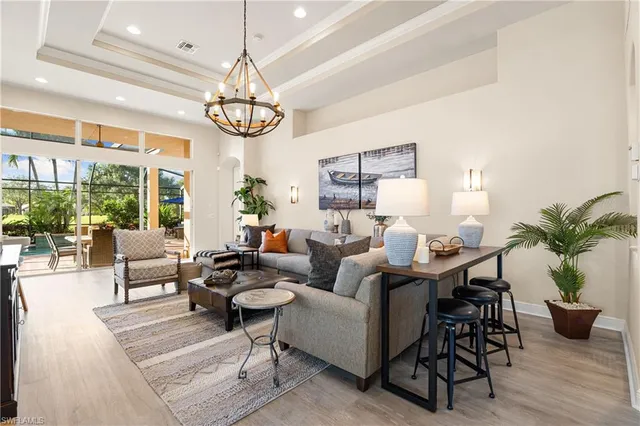 a living room with furniture or chandelier and a wooden floor