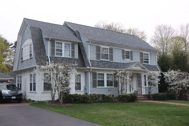 a front view of a house with a garden