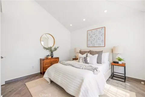 a bedroom with a bed and a mirror