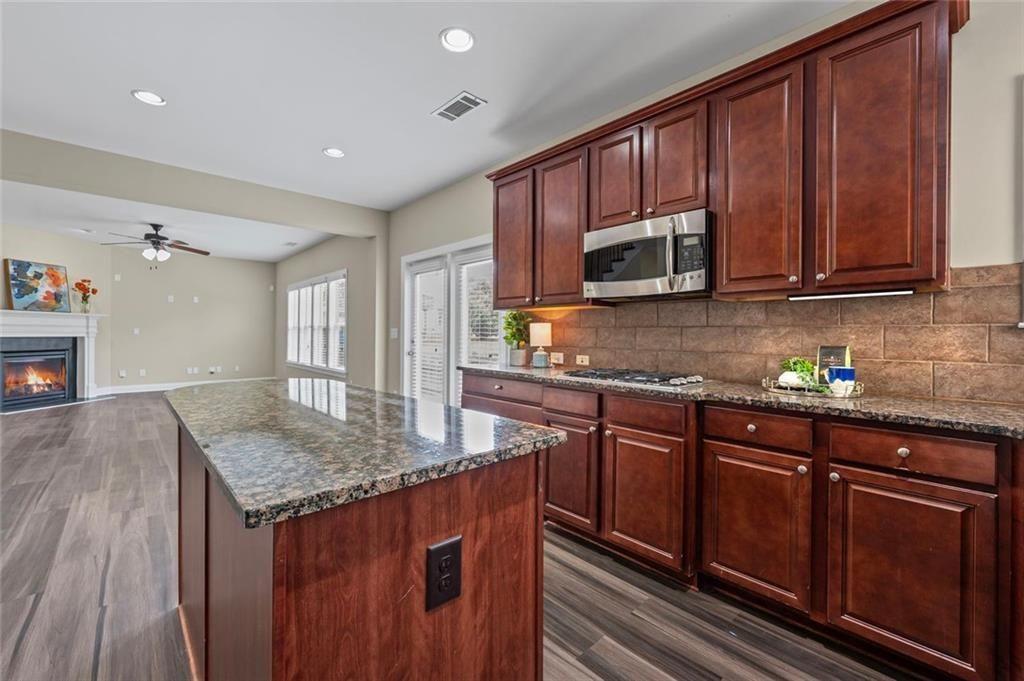 29 Lankford Road Tucker, GA 30084 - Photo 14 of 43 a kitchen with granite countertop wooden cabinets a sink and dishwasher