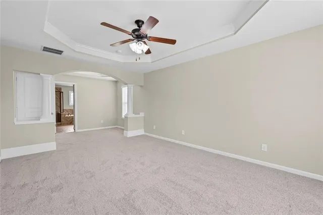 a view of a livingroom with a ceiling fan and window