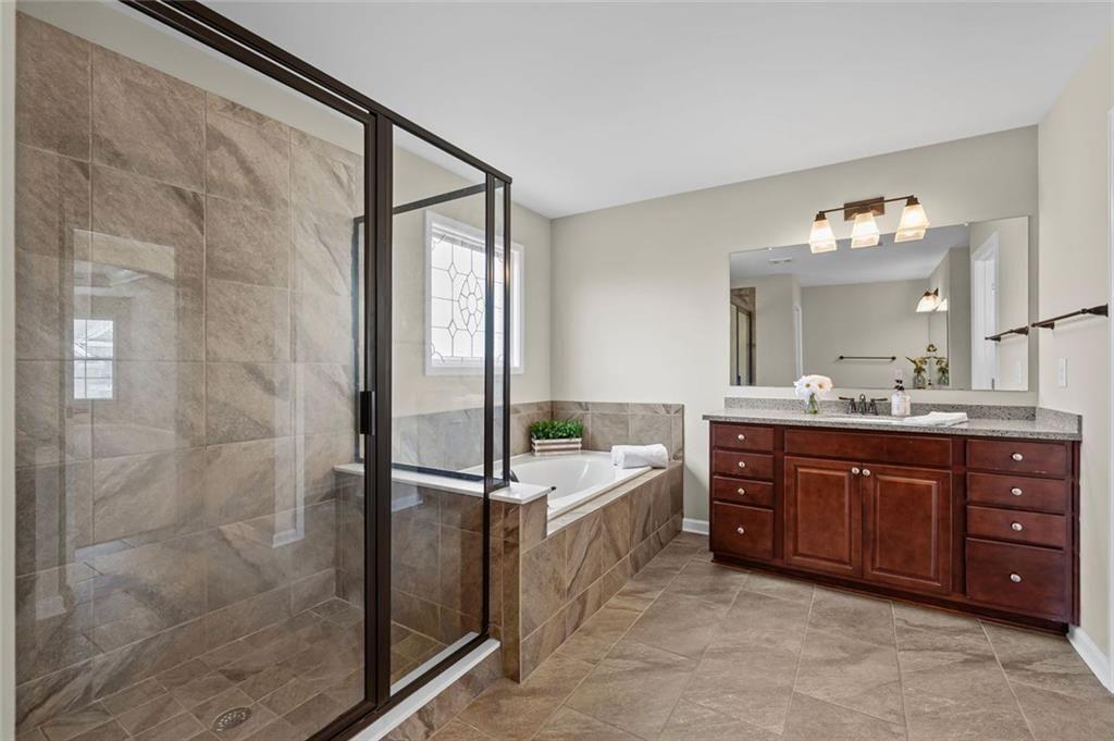 29 Lankford Road Tucker, GA 30084 - Photo 21 of 43 a spacious bathroom with a tub sink and mirror