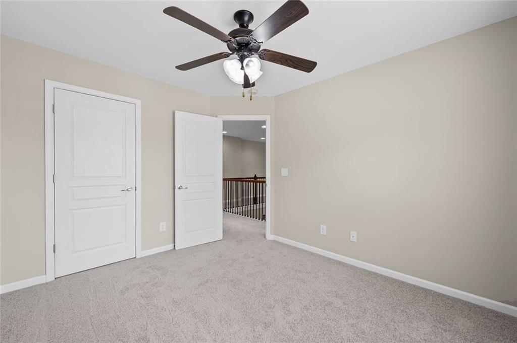 29 Lankford Road Tucker, GA 30084 - Photo 32 of 43 an empty room with a ceiling fan and a window
