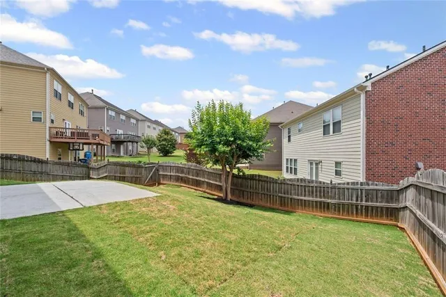 a view of a house with pool and sitting area