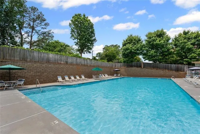 a view of a swimming pool with a yard