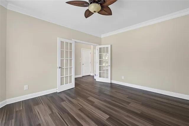 a view of empty room with wooden floor