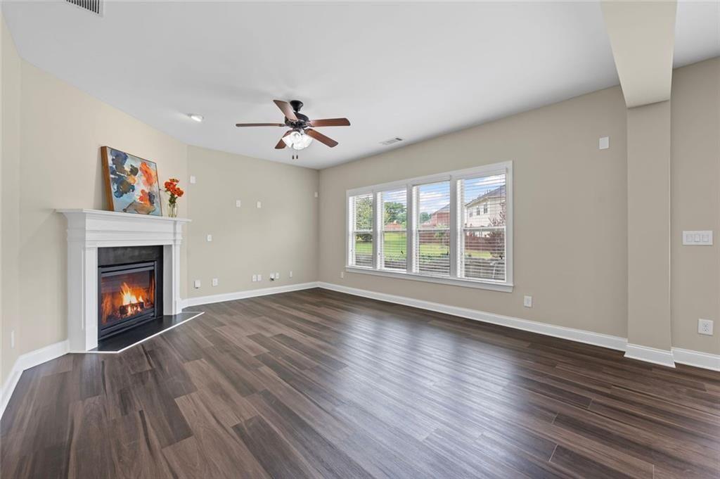 29 Lankford Road Tucker, GA 30084 - Photo 10 of 43 a view of an empty room with wooden floor a fireplace and a window