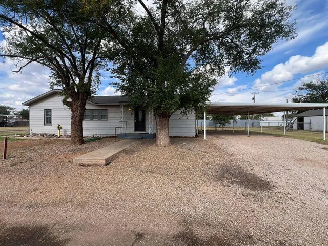 a view of a house with a yard and tree