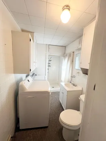 a bathroom with a toilet sink and mirror