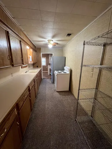 a kitchen with sink cabinets and window