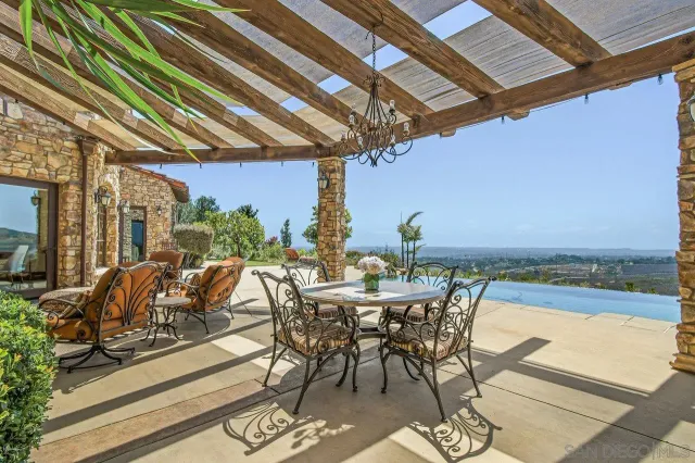 a view of a patio with swimming pool table and chairs