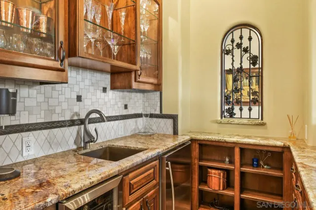 a kitchen with stainless steel appliances granite countertop a sink and cabinets