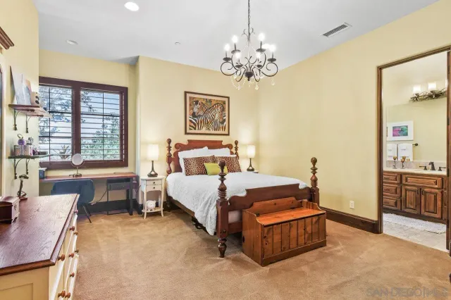 a spacious bedroom with a bed and a table in it