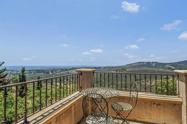a balcony with table and chairs