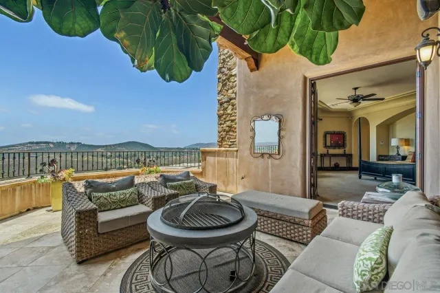 a balcony with furniture and a potted plant