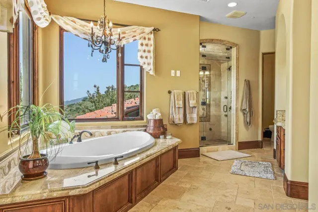 a spacious bathroom with a granite countertop tub sink and mirror
