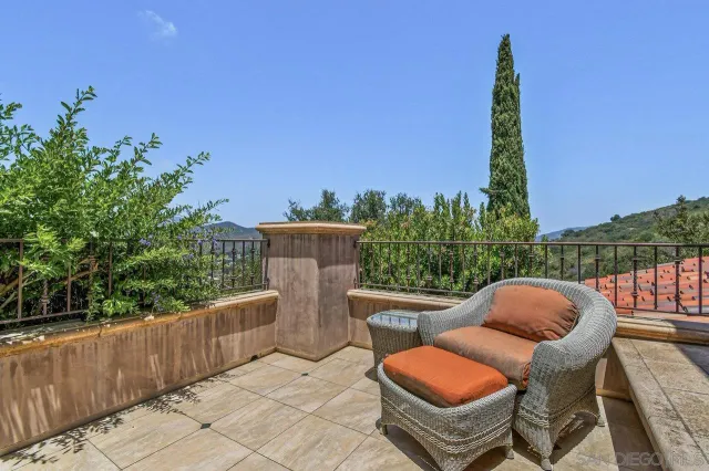 a view of a chairs and table in the roof deck