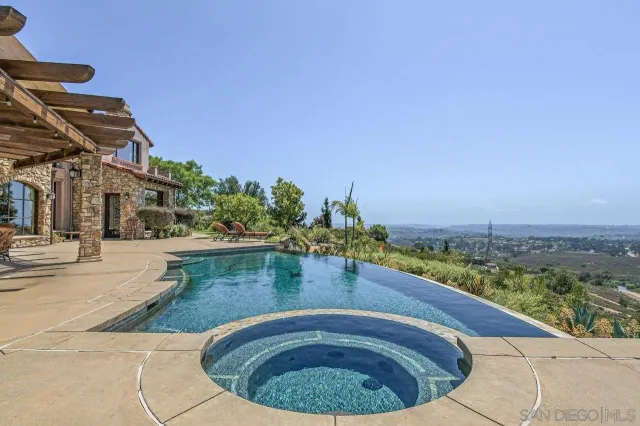 a view of a swimming pool with a table and chairs