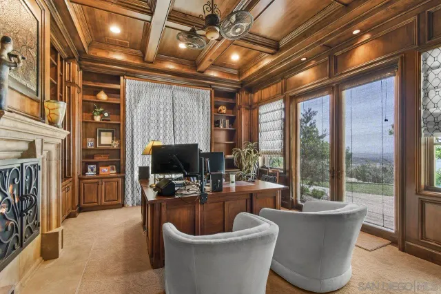 a living room with furniture a flat screen tv and a large window
