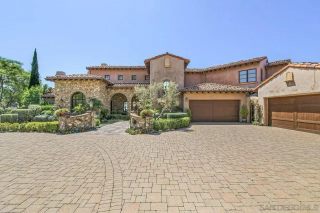 a front view of a building with a yard and garage