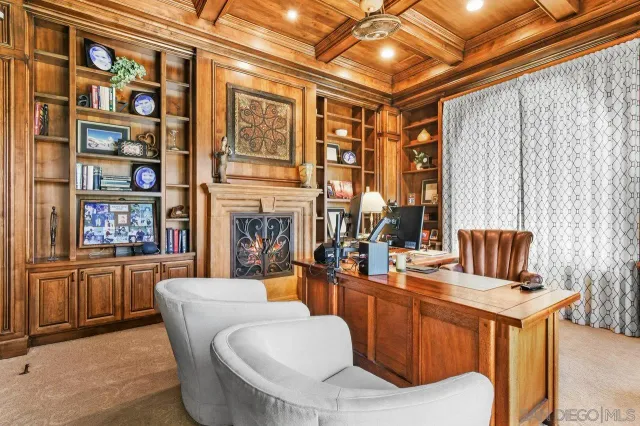 a living room with fireplace furniture and a window