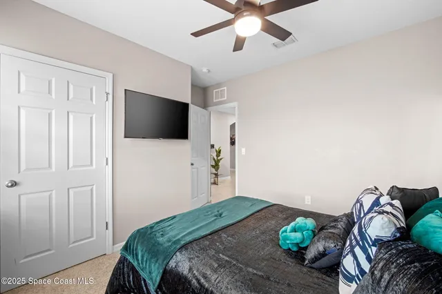 a bedroom with a bed and a flat screen tv