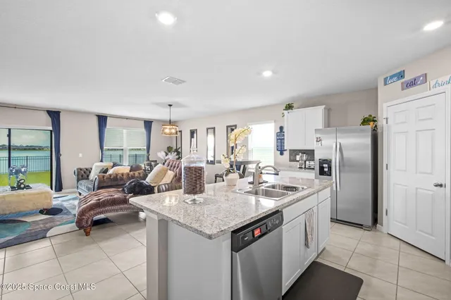 a kitchen with a sink refrigerator and cabinets