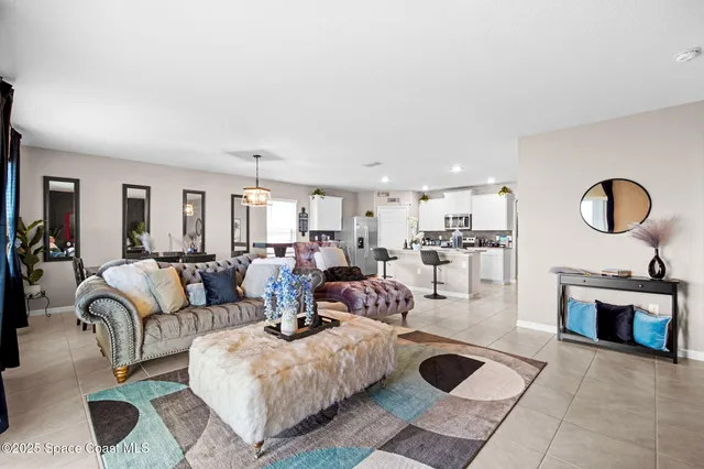 a living room with furniture a rug and white walls