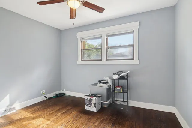 a view of a workspace with wooden floor