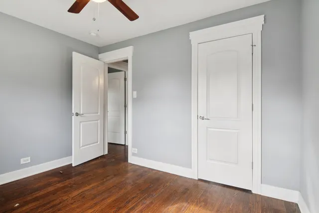 an empty room with wooden floor and closet