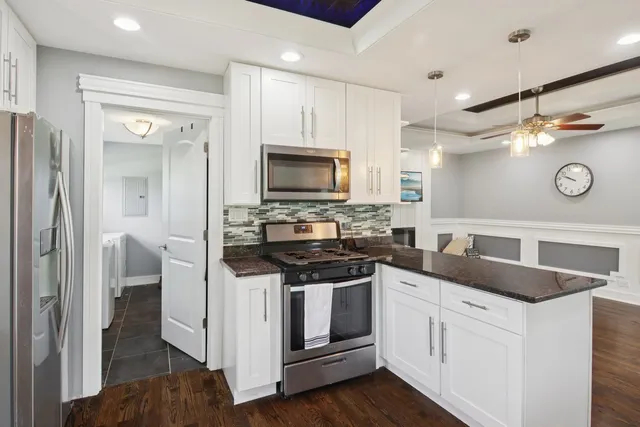 a kitchen with stainless steel appliances granite countertop a stove and a sink