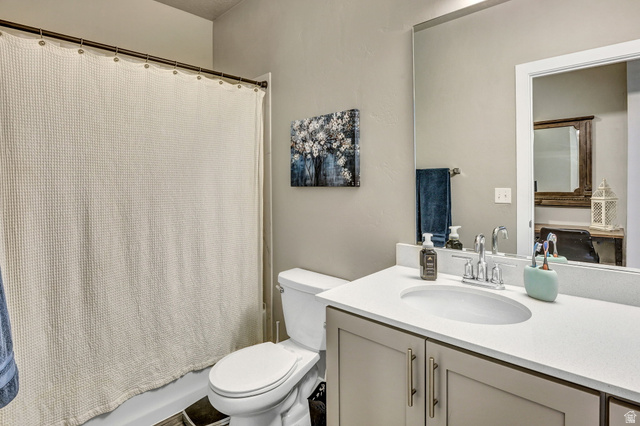 2101 North Main Street, Unit 306 Sunset, UT 84015 - Photo 17 of 22 Bathroom with a single vanity featuring a built-in sink, light countertop, and under-sink cabinetry