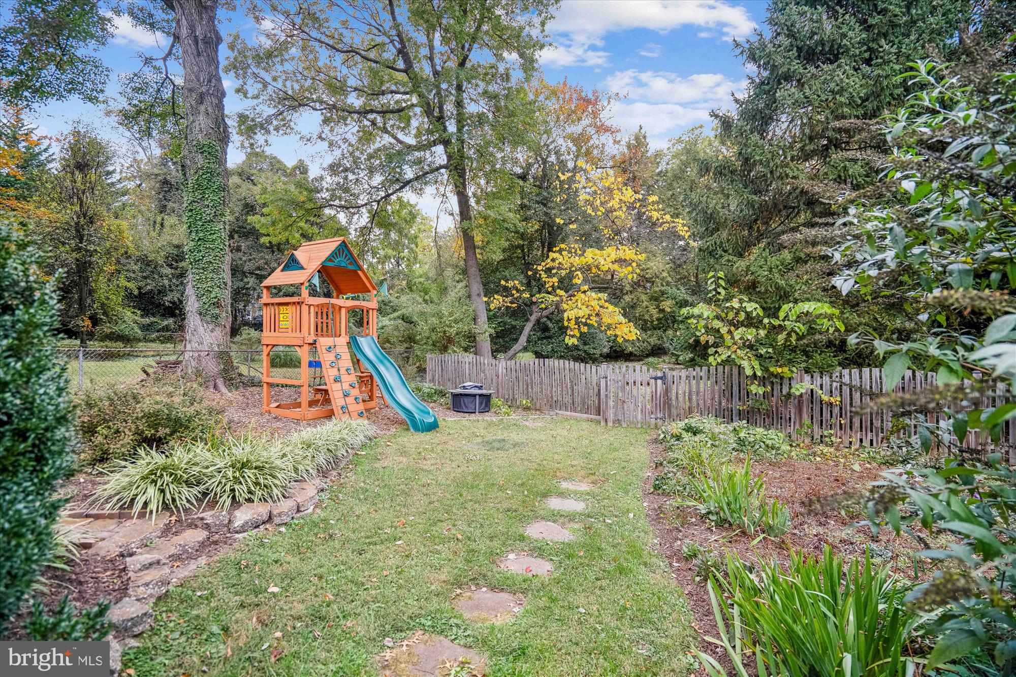 751 Silver Spring Avenue Silver Spring, MD 20910 - Photo 54 of 71 a view of a backyard with plants and a slide