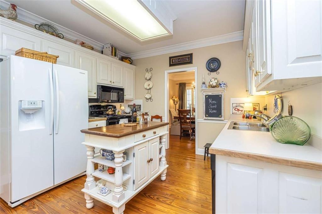 6009 Big A Road Douglasville, GA 30135 - Photo 12 of 50 a kitchen with stainless steel appliances a stove a sink and a refrigerator