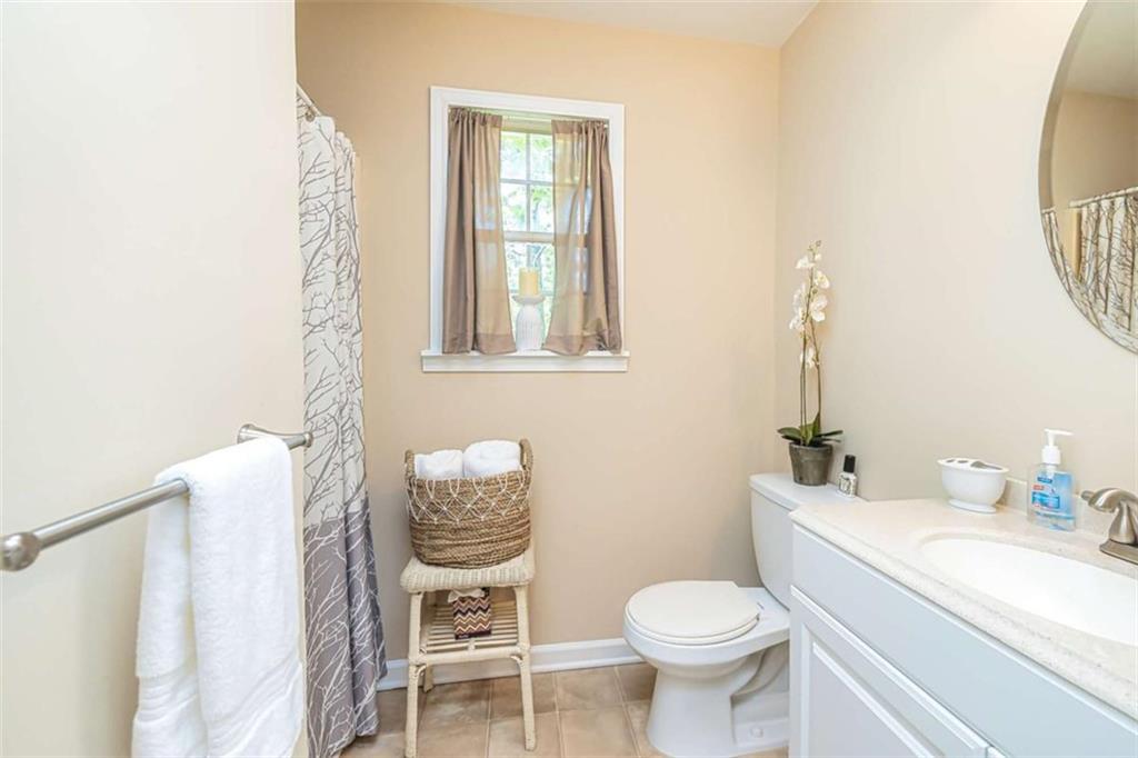 6009 Big A Road Douglasville, GA 30135 - Photo 42 of 50 a bathroom with a toilet sink and mirror