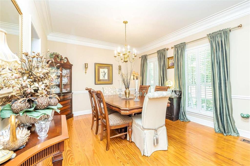 6009 Big A Road Douglasville, GA 30135 - Photo 8 of 50 a dining room with furniture a chandelier and wooden floor