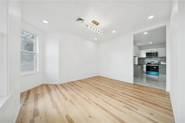 a view of kitchen and hall with wooden floor