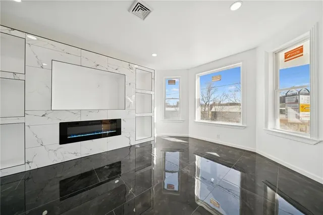 a living room with furniture wooden floor and window