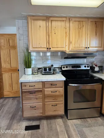 a kitchen with granite countertop a stove and a sink