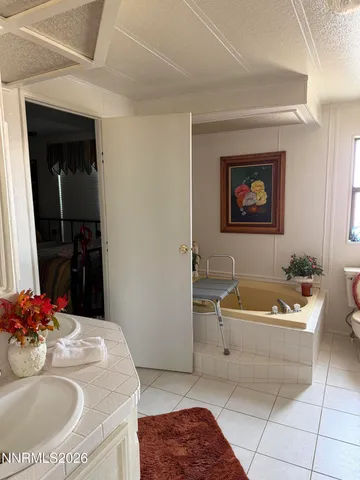 a bathroom with a tub sink and mirror