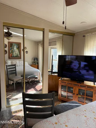 a bedroom with furniture and a flat screen tv