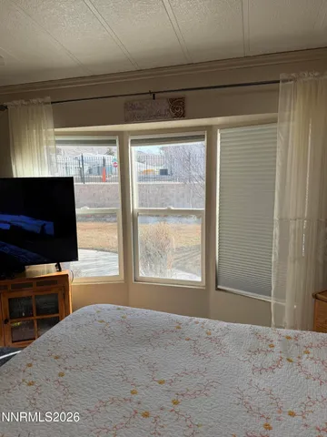 a view of a livingroom with furniture and a flat screen tv